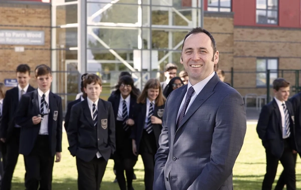 Mr M. McElwee, Academy Headteacher, pictured in front of the school building