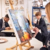 A student painting during an art lesson