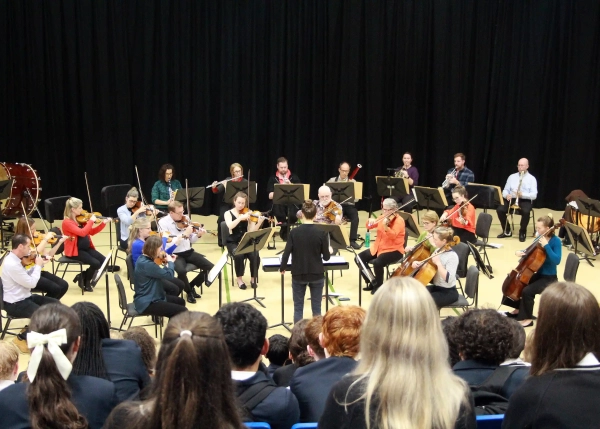 Musicians playing instruments to students