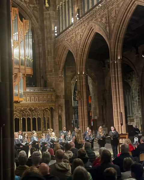 Students singing for an audience in the cathedral